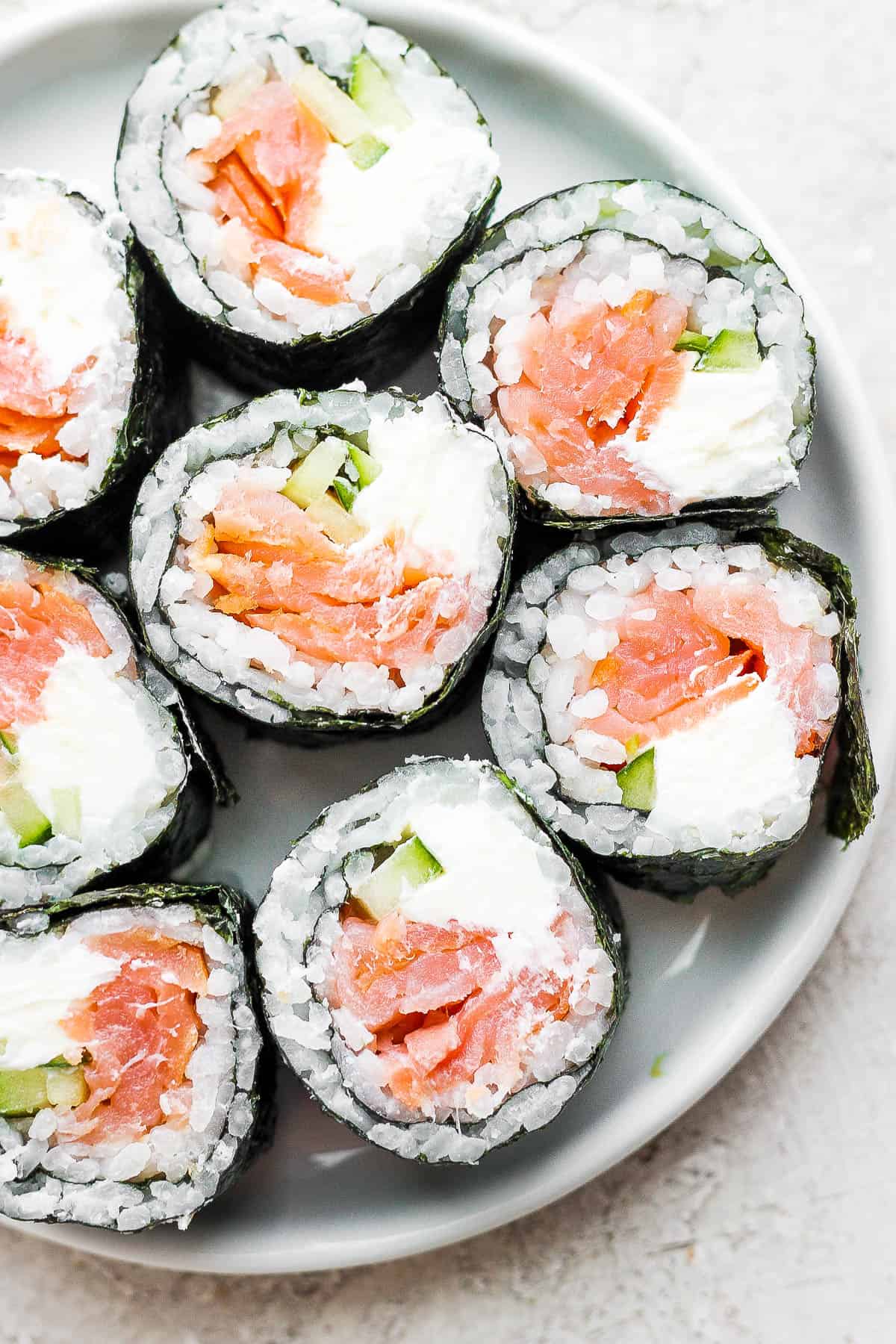 Pieces of a philadelphia roll on a plate.