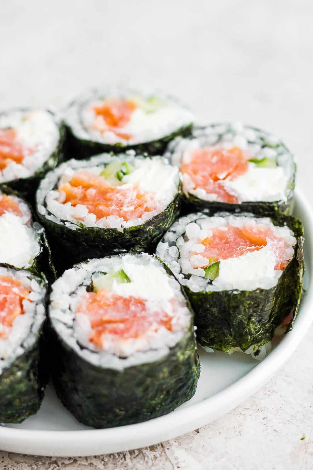 Pieces of a philadelphia roll on a plate.