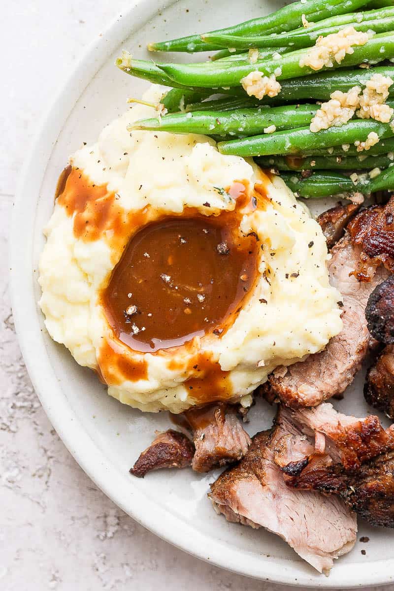 Up close shot mashed potatoes and pork gravy.