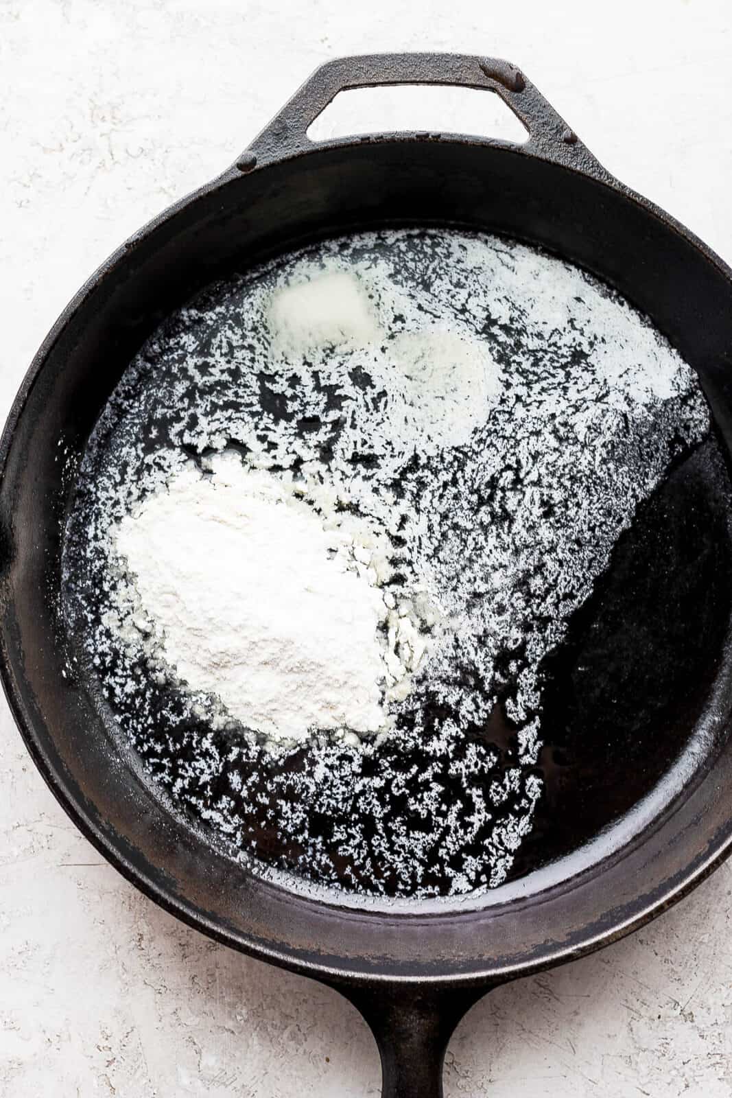 Cast iron skillet with melted butter and flour inside. 