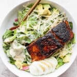 Bowl of salmon caesar salad.