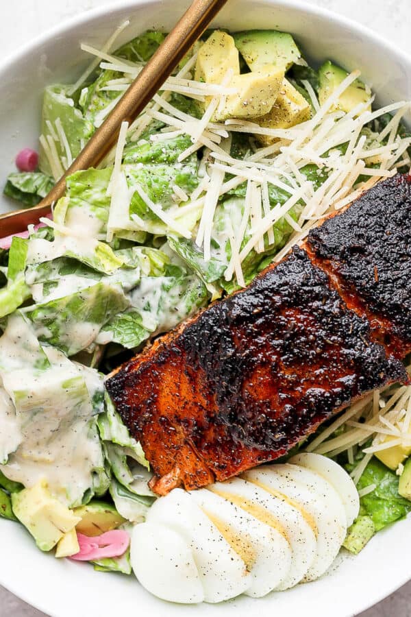 Bowl of salmon caesar salad.