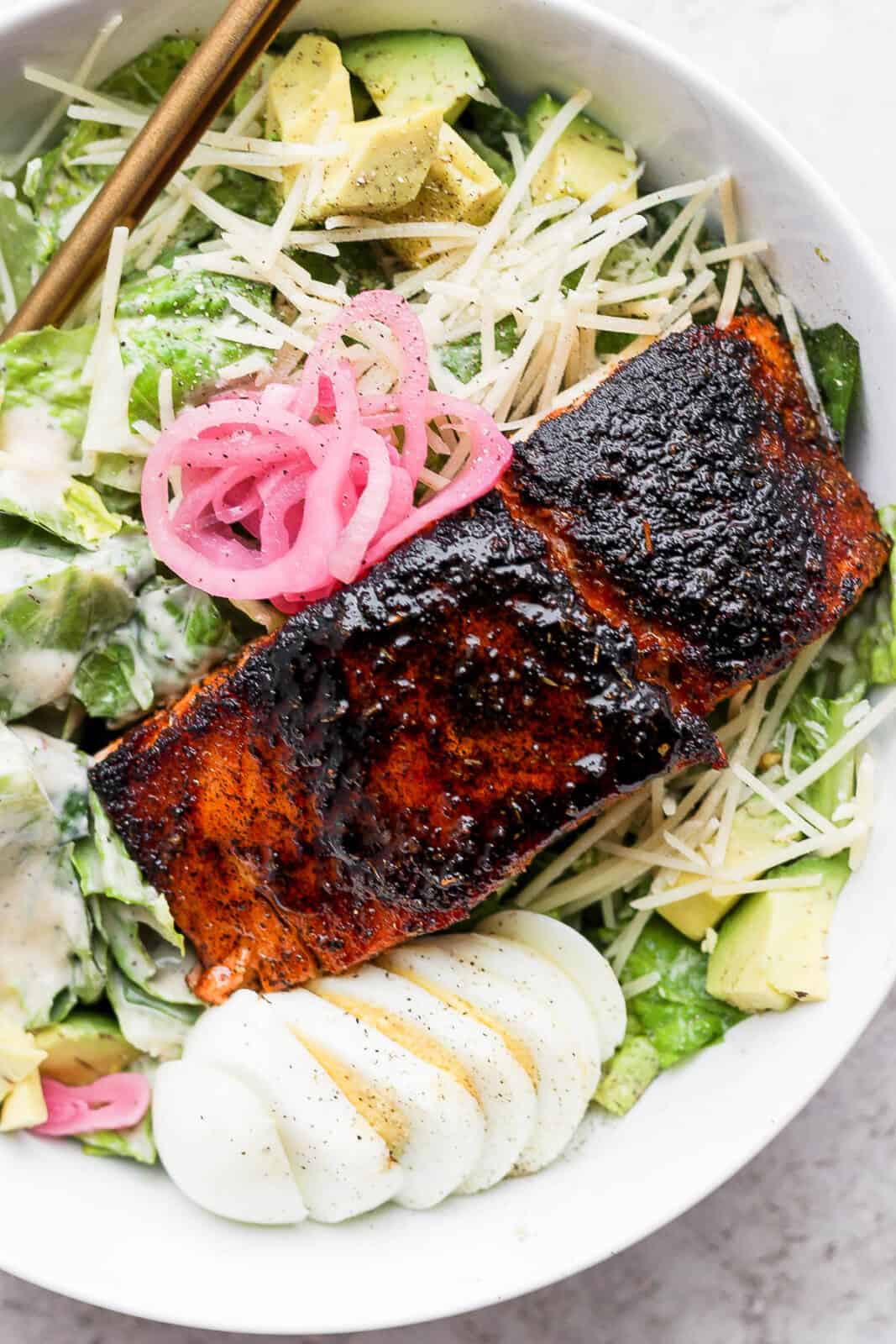 Blackened salmon on a caesar salad.