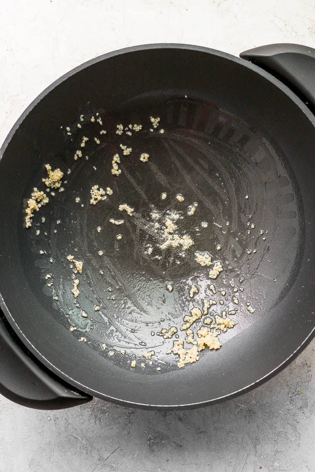 Garlic sautéing in a wok.