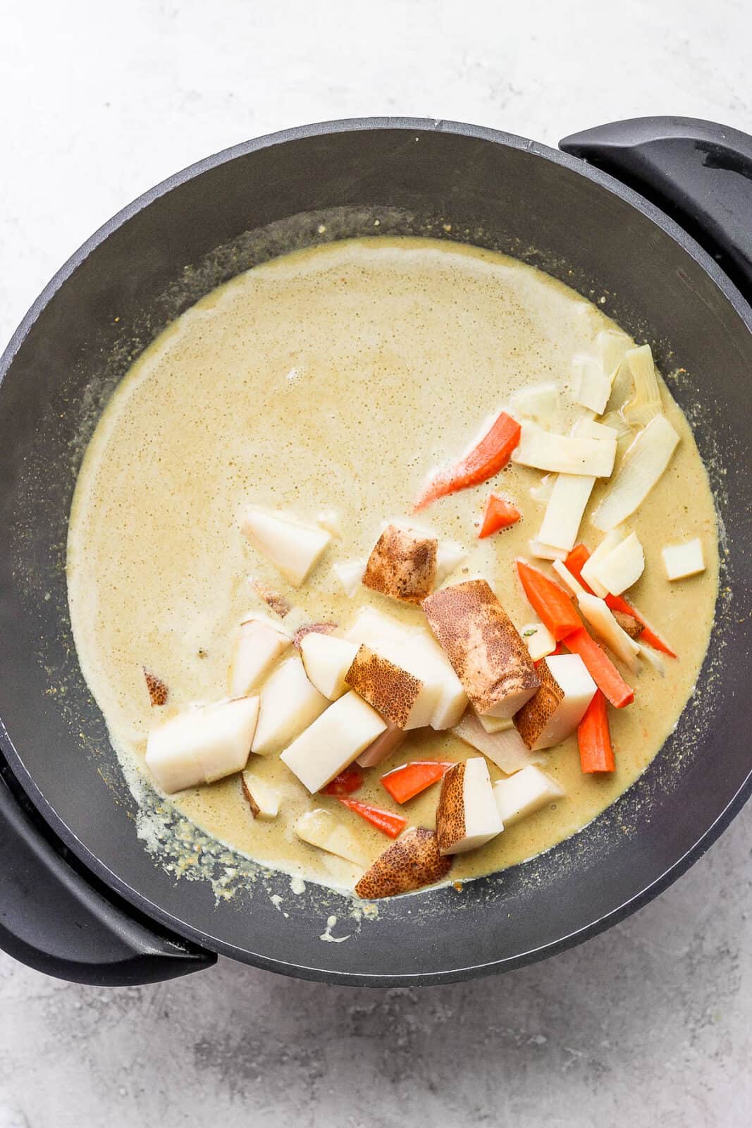 Potato, carrots, and bamboo shoots added to the wok.