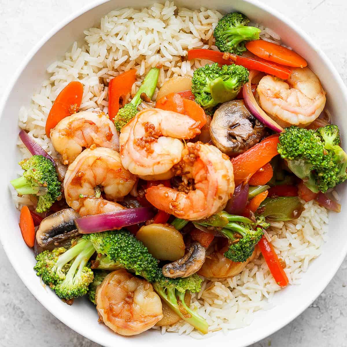 Bowl of shrimp stir fry over rice.