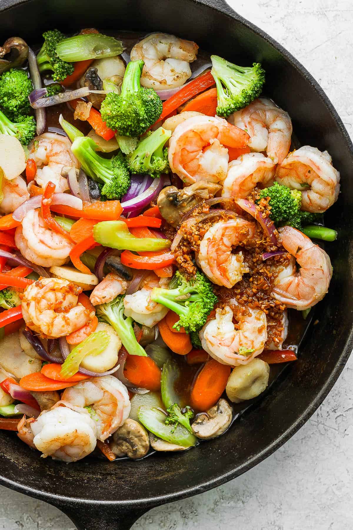 Shrimp stir fry in a cast iron skillet.