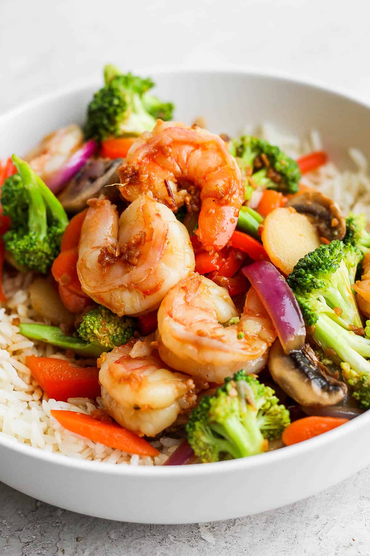 Shrimp stir fry in a bowl with rice.