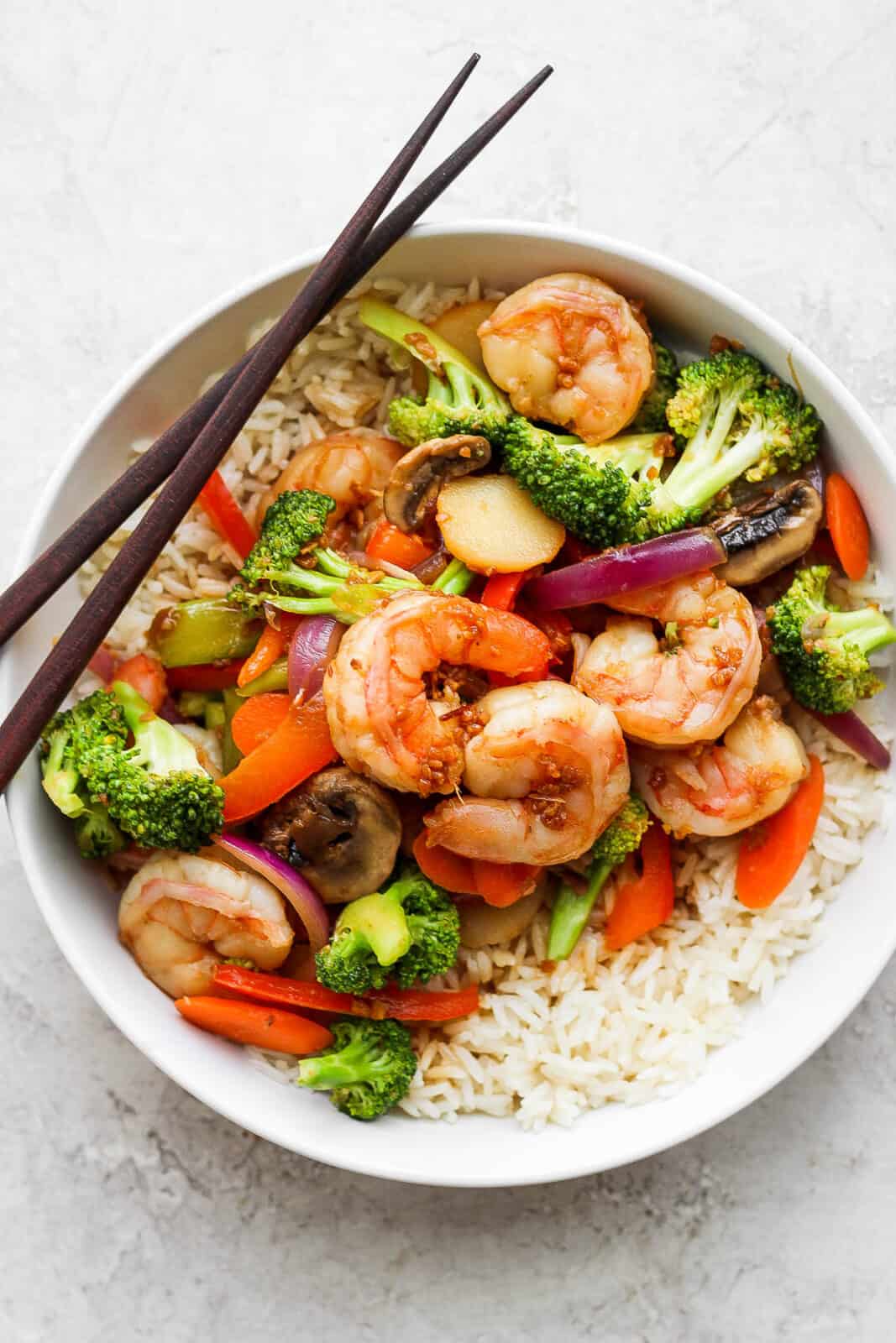 Shrimp stir fry in a bowl with rice.