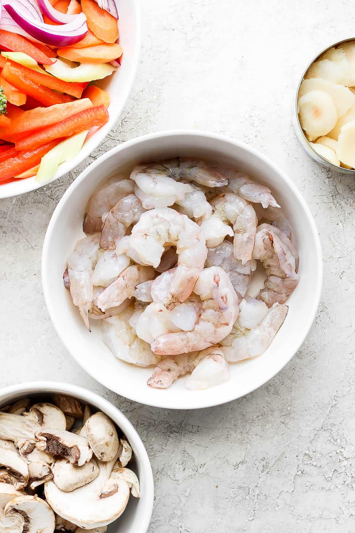 A bowl of raw shrimp.