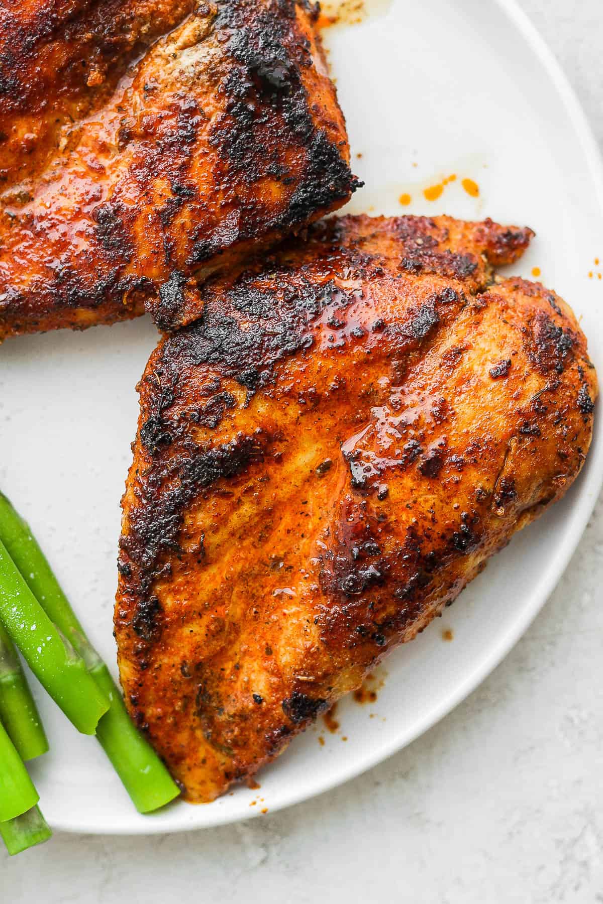 Blackened chicken breast on a plate.