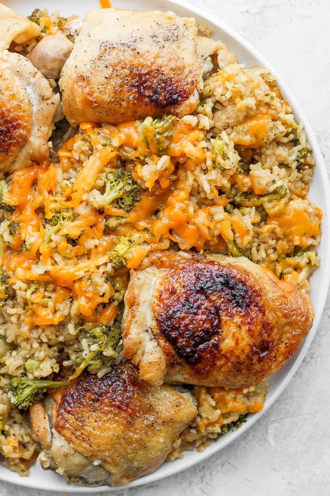 A plate of cheesy chicken broccoli and rice.