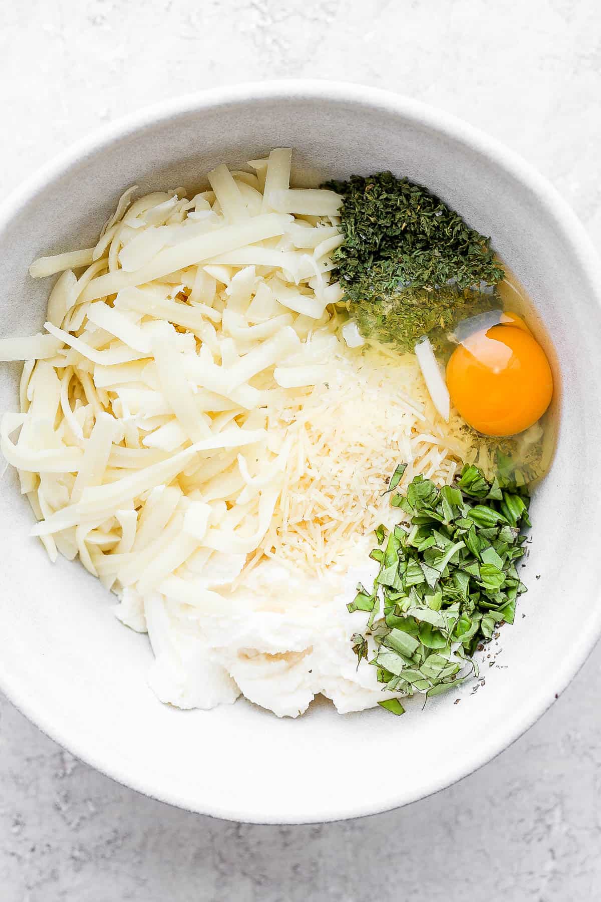 Ingredients for ricotta mixture in a mixing bowl.