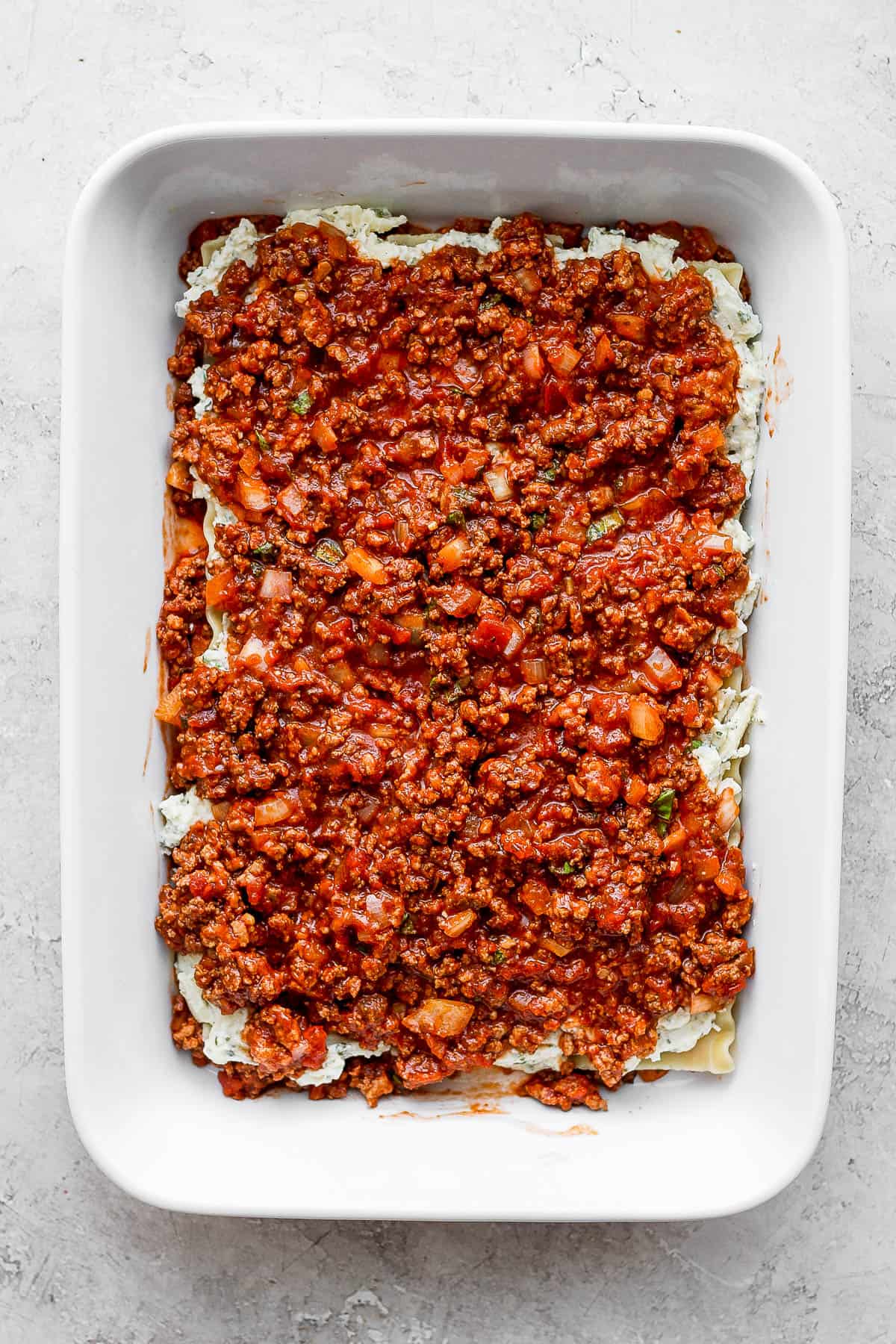 More meat sauce added on top of the ricotta mixture.