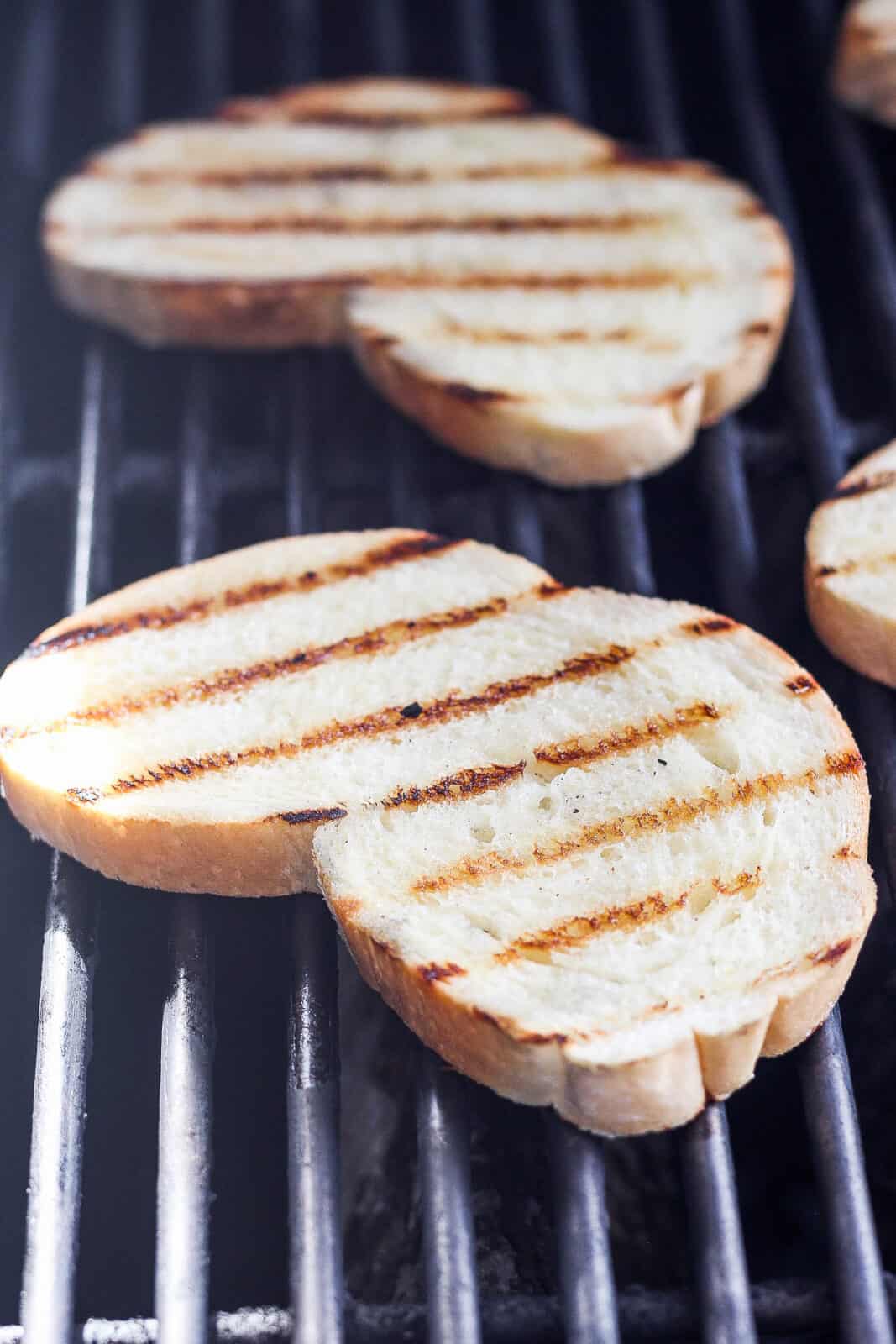 Close-up of grilled bread on the grill.