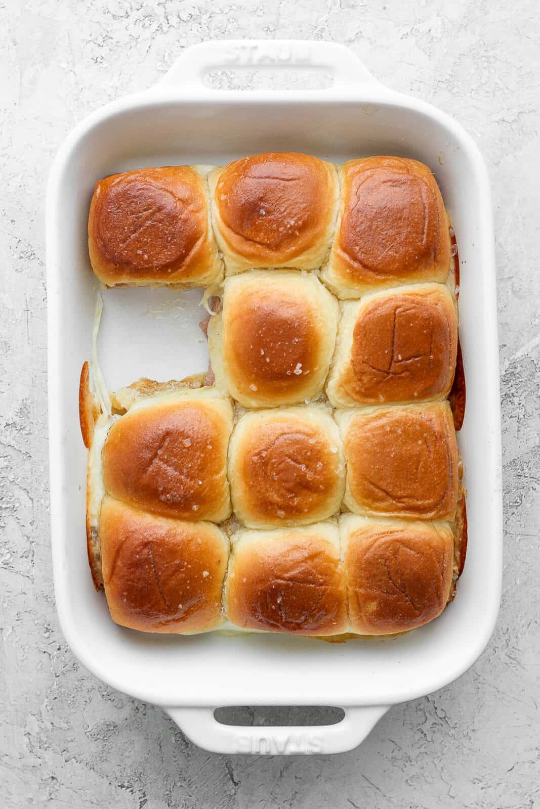 The dish of sliders with one slider missing.