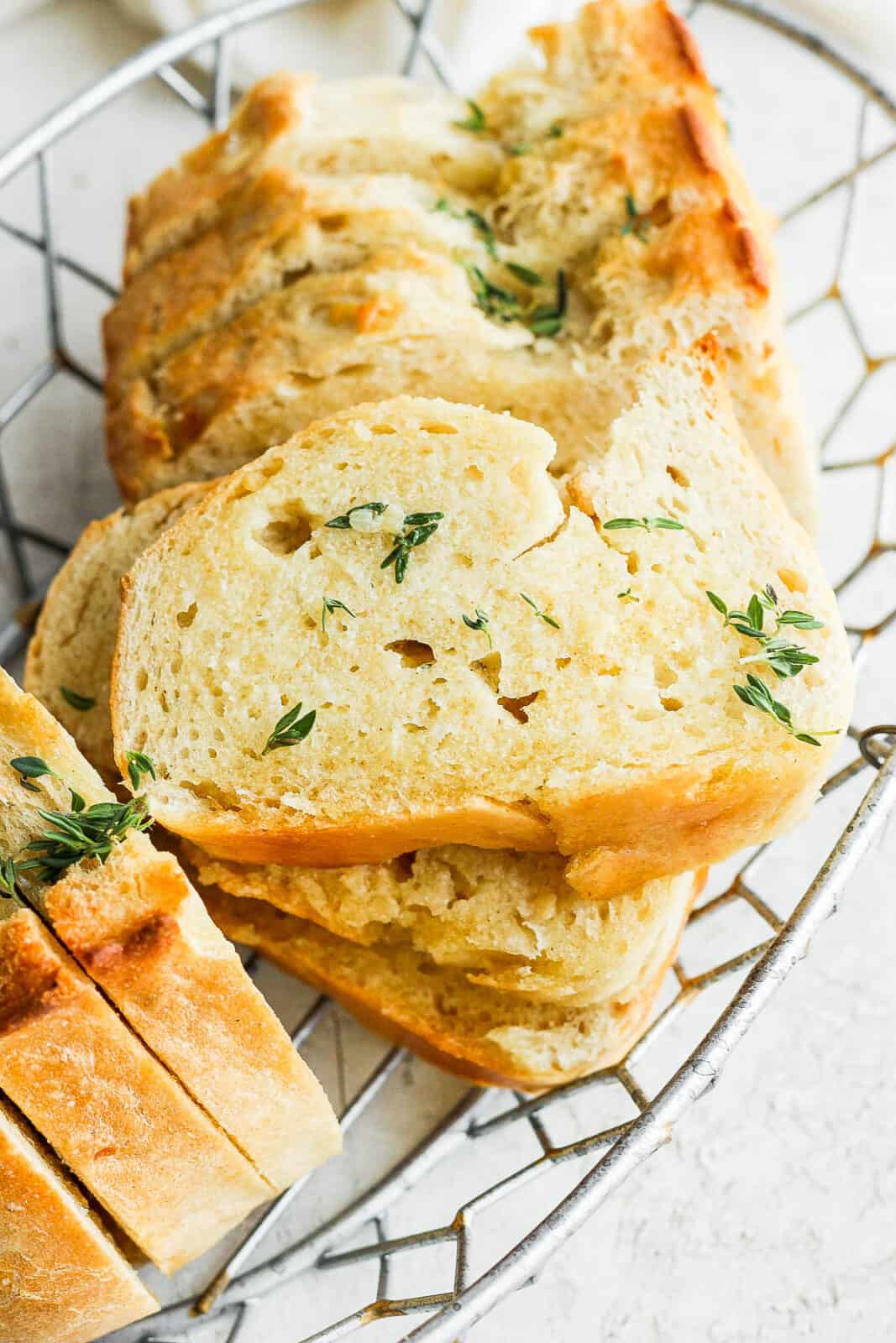 Sliced garlic bread in a basket.
