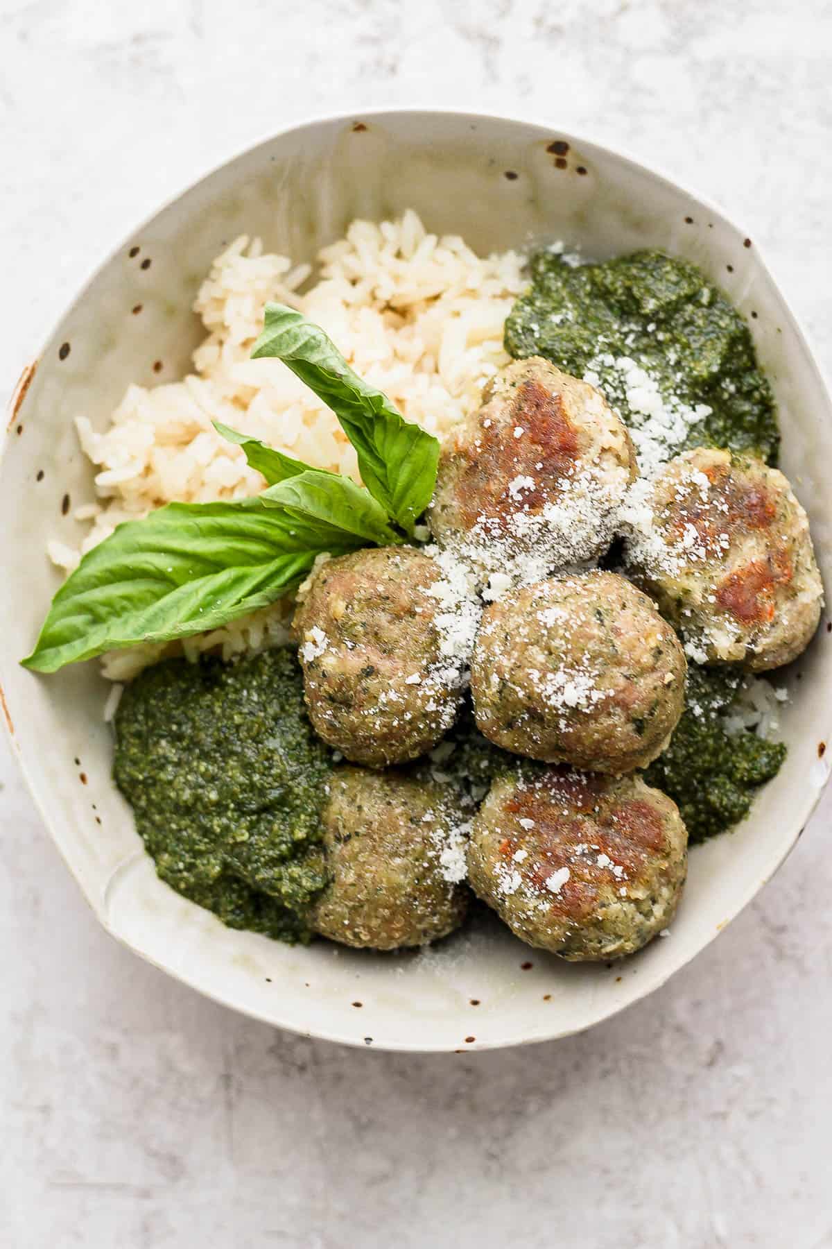 Bowl of rice, pesto and pesto meatballs. 