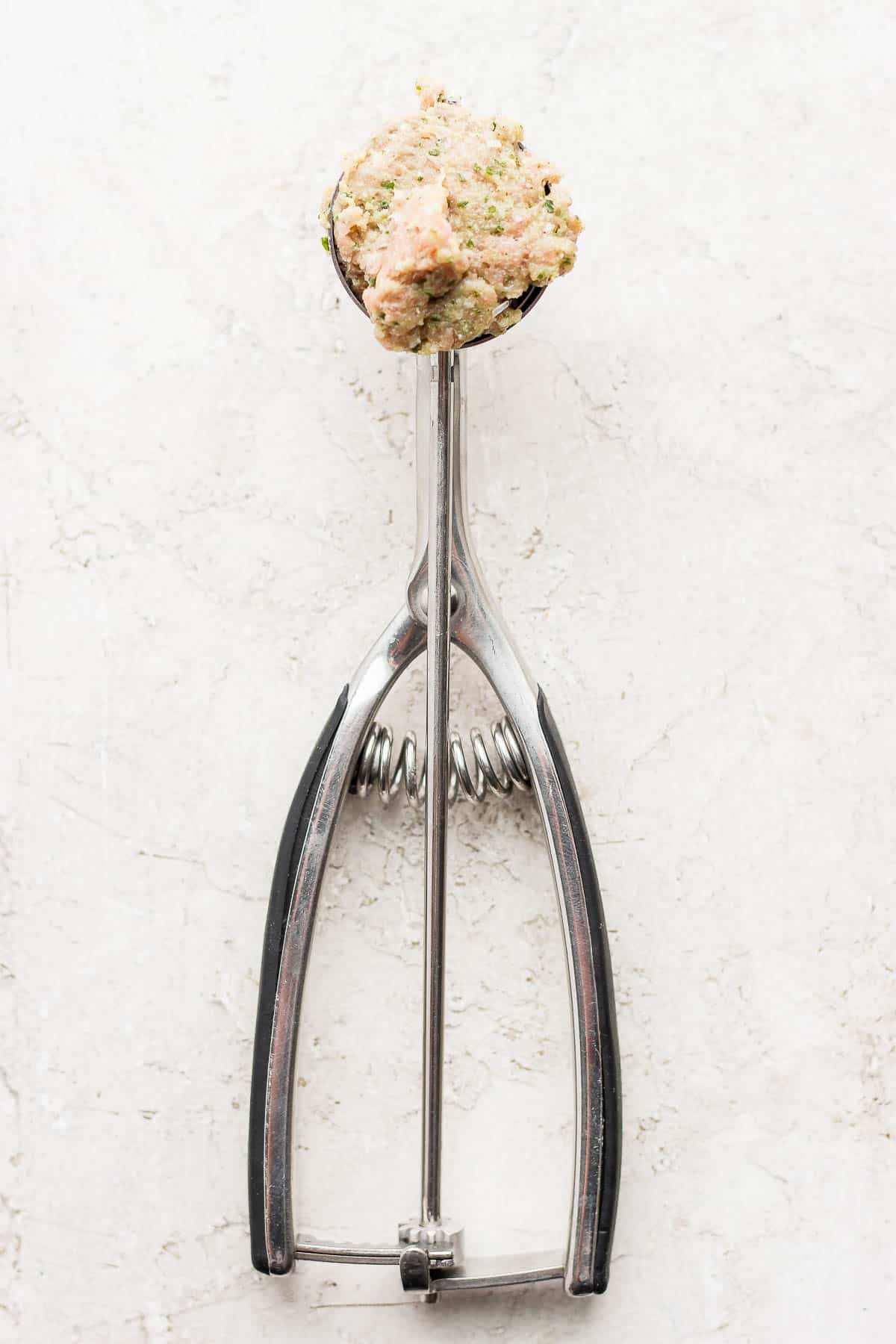 Cookie dough scoop with meatball mix inside. 