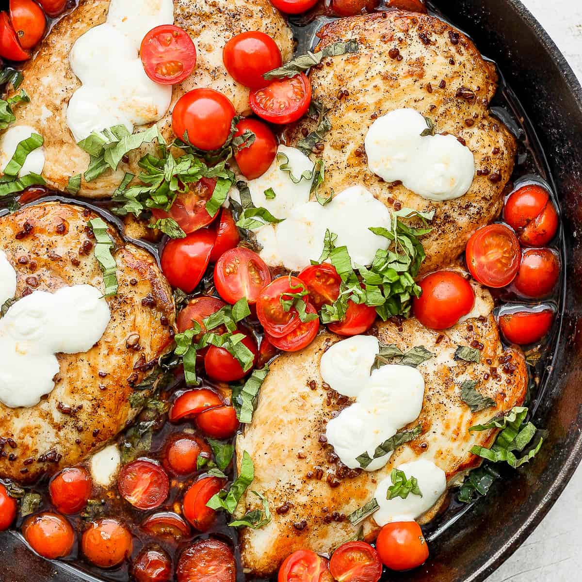 Cast iron skillet filled with balsamic chicken.