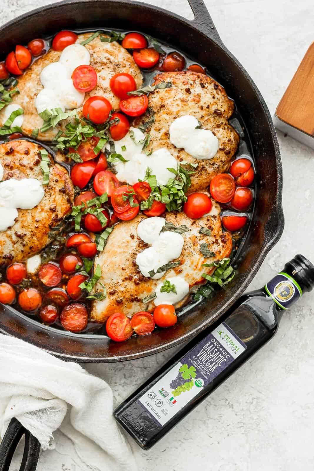 Cast iron skillet filled with balsamic chicken. 