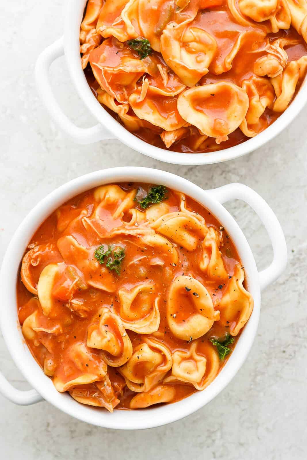 Two bowls of creamy, dairy-free chicken tortellini soup.