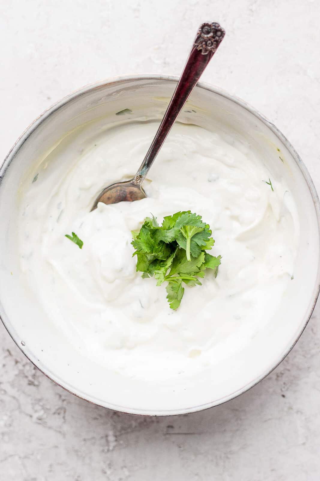 Cilantro lime crema mixed together in a bowl.