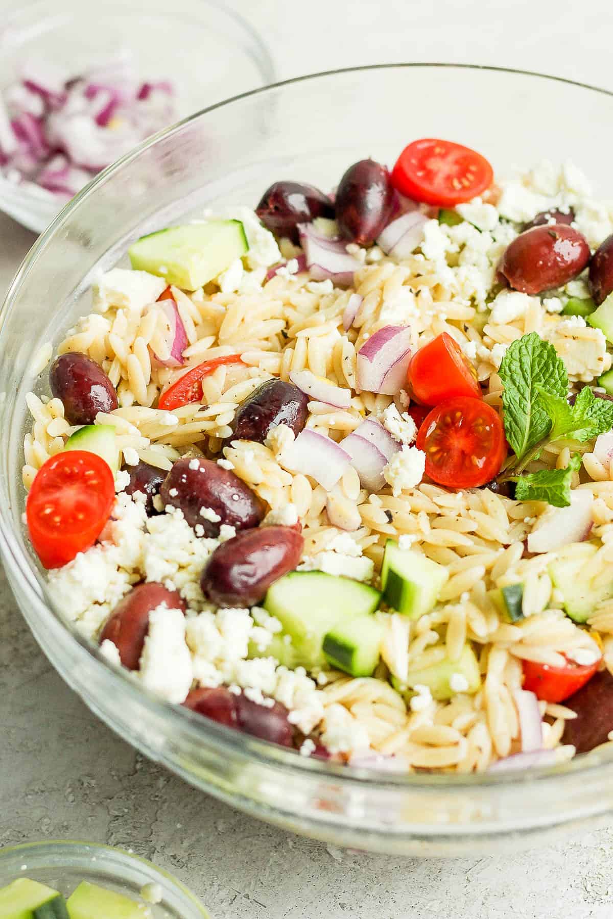 Side angle of a bowl of Greek Orzo Salad. 