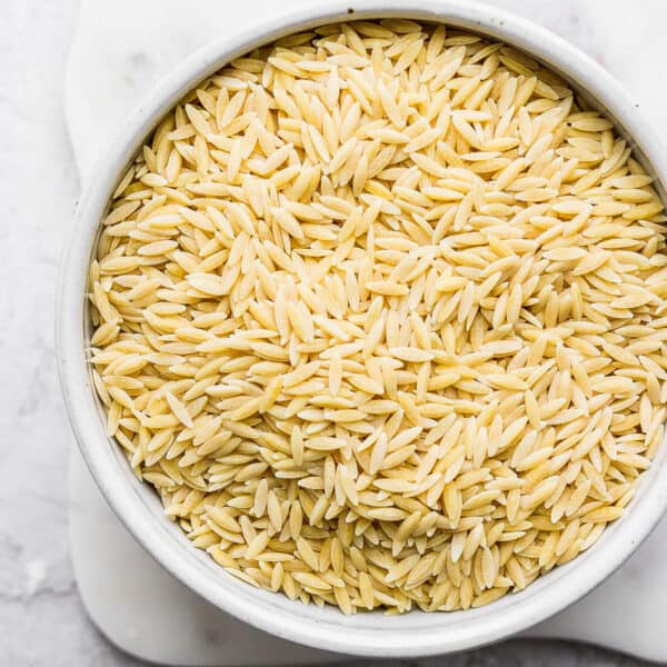 A bowl of uncooked orzo.