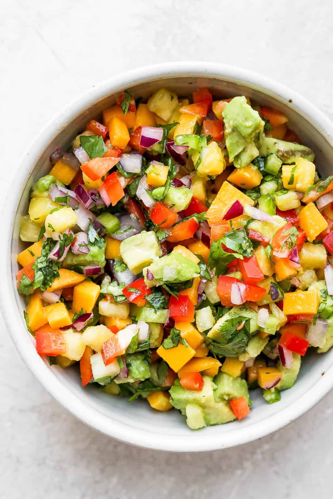 A large bowl of mango pineapple salsa.