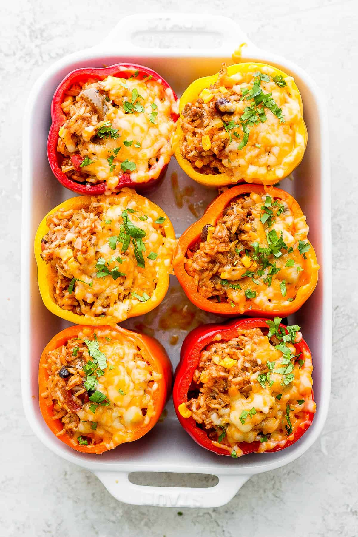 Mexican Stuffed Peppers just out of the oven with melted cheese. 