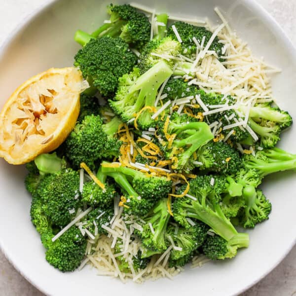 Bowl of parmesan broccoli with lemon.