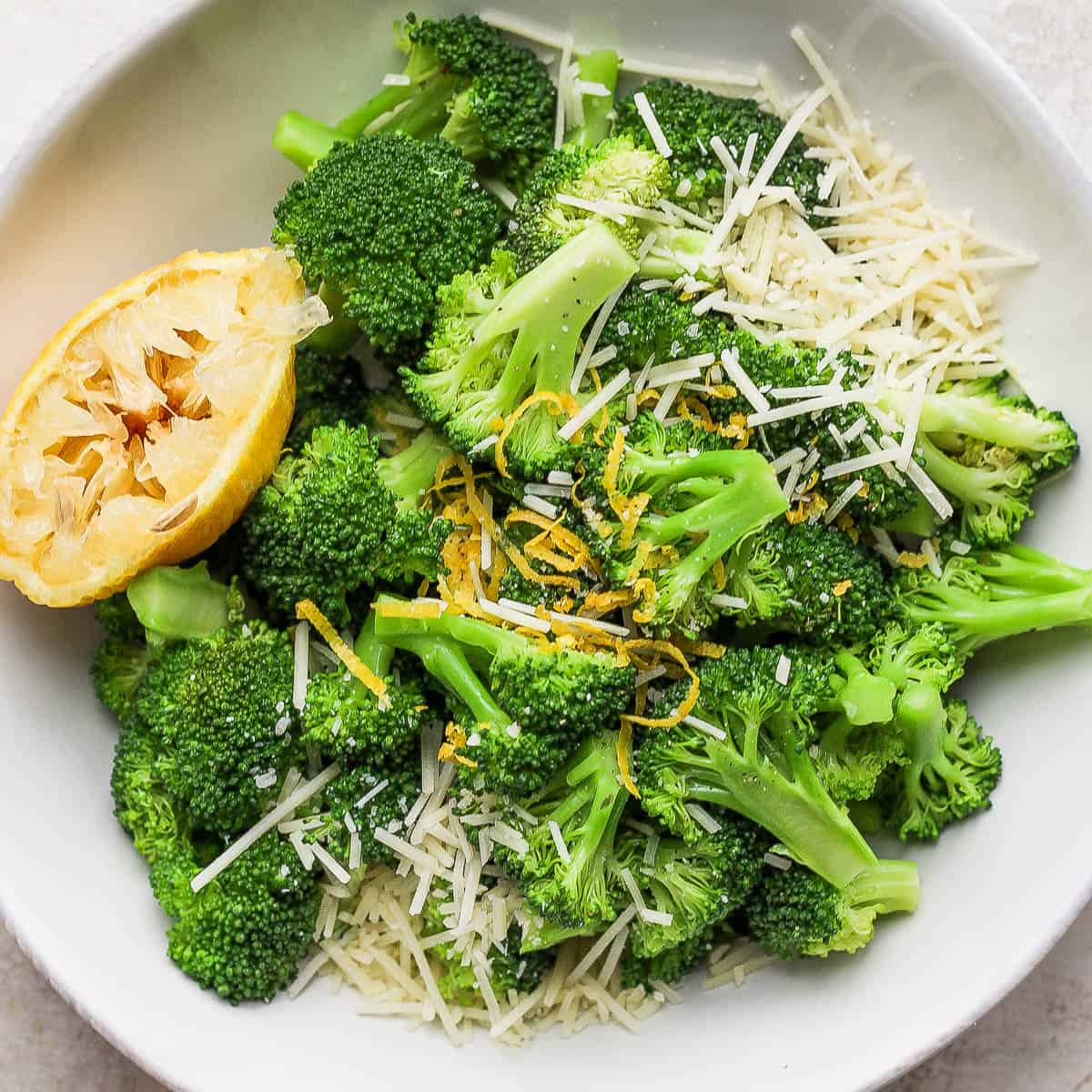 Bowl of parmesan broccoli with lemon.