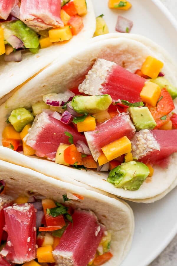 Plate of three ahi tuna tacos with mango salsa.