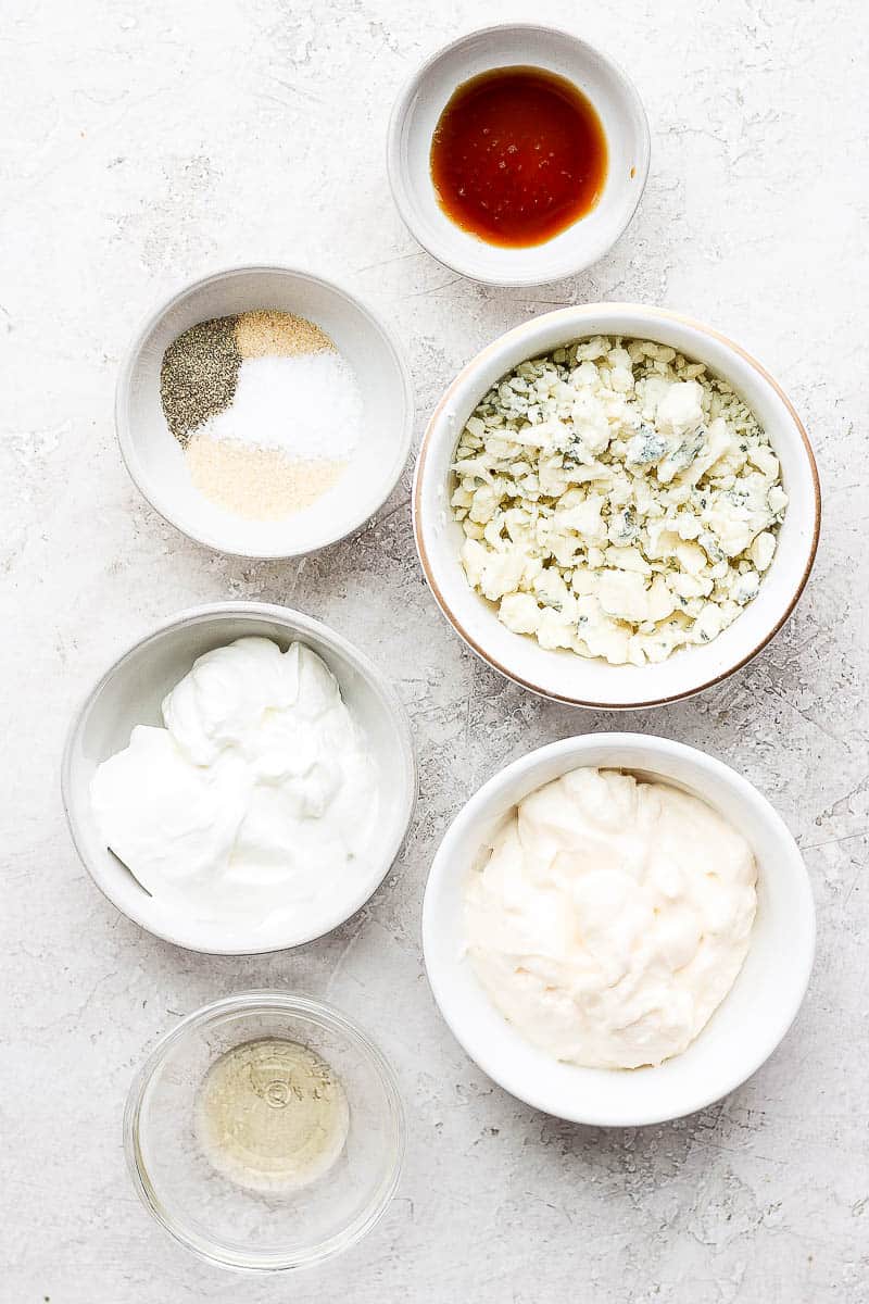 Blue cheese dressing ingredients in small bowls.