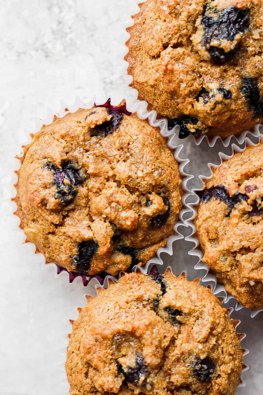 Healthy blueberry banana muffins in muffin cups.