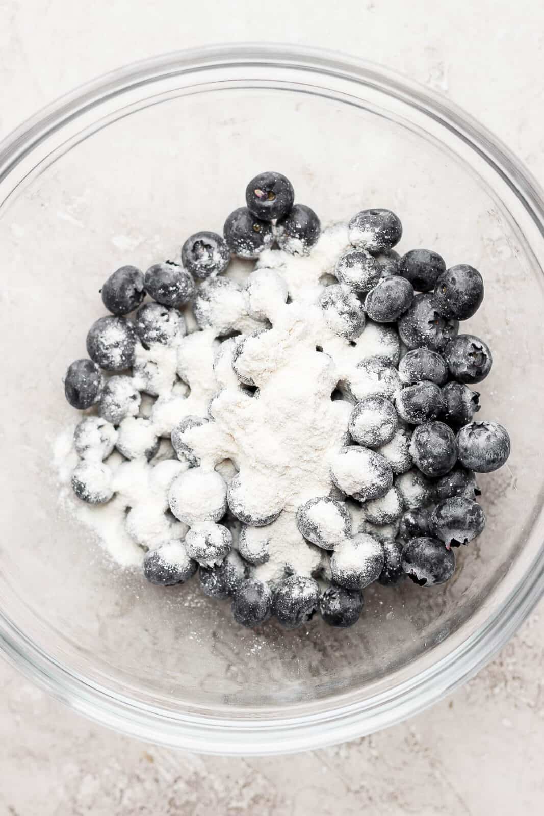 Blueberries in a bowl with a bit of cassava flour.
