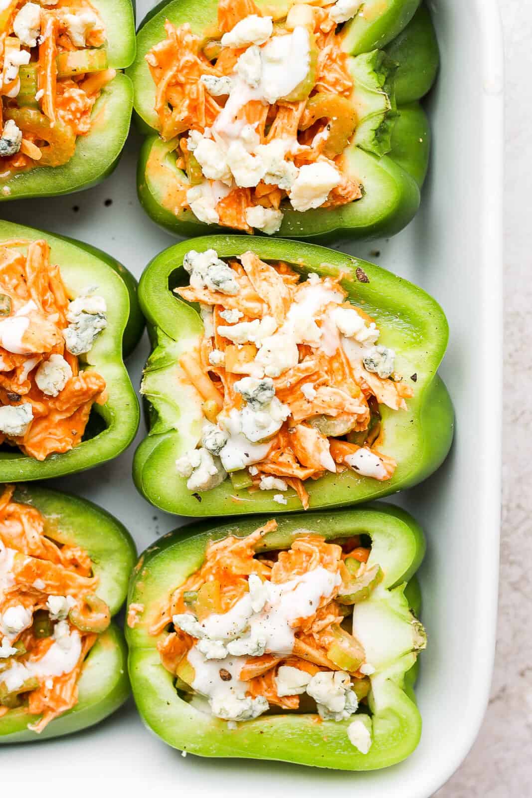 Quick and easy buffalo chicken stuffed peppers in a baking dish.