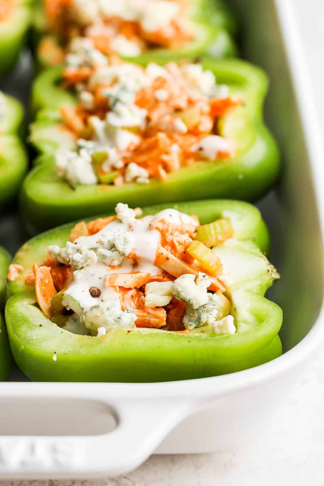 A buffalo chicken stuffed pepper with toppings on top.