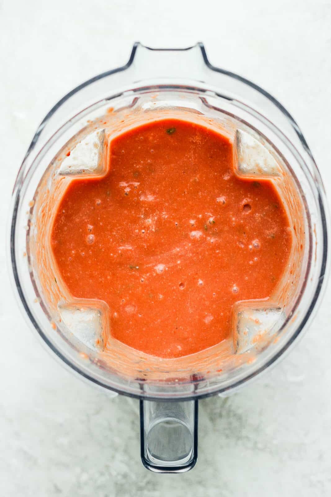 Blended creamy tomato basil soup in the blender.