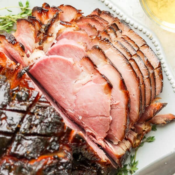 A honey glazed ham on a platter.