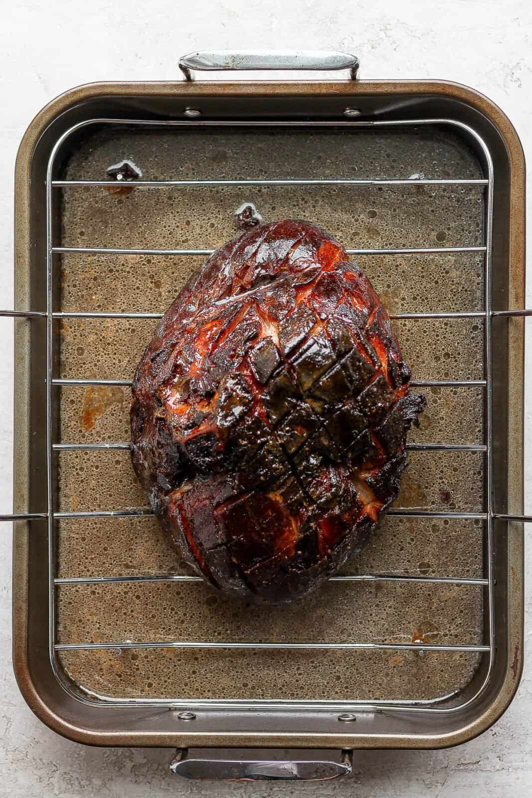 A cooked ham in a roaster.