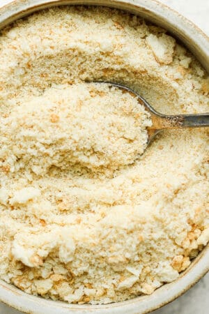 Bowl of homemade bread crumbs with spoon sticking out of it.