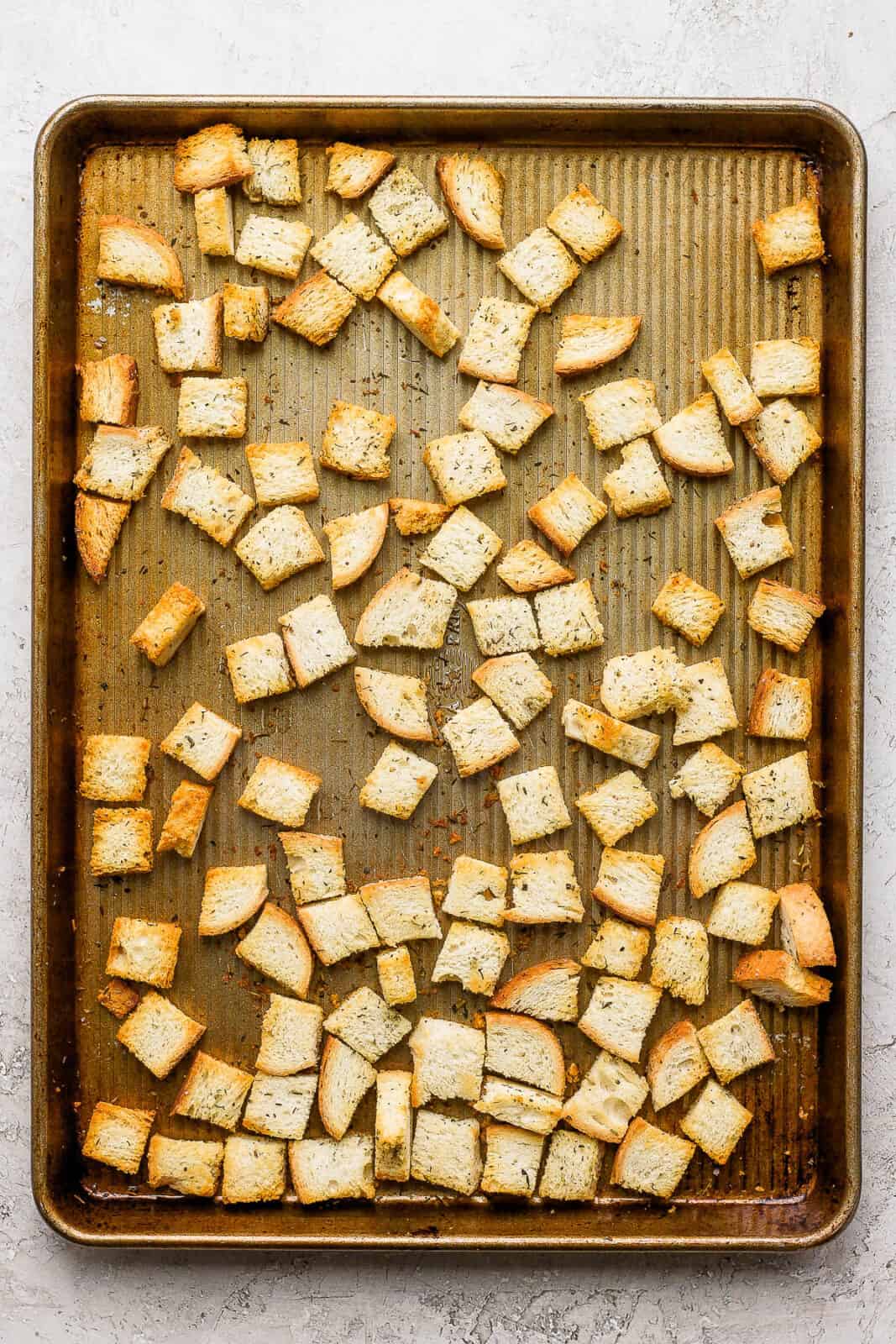 Baked croutons on a baking sheet after baking.
