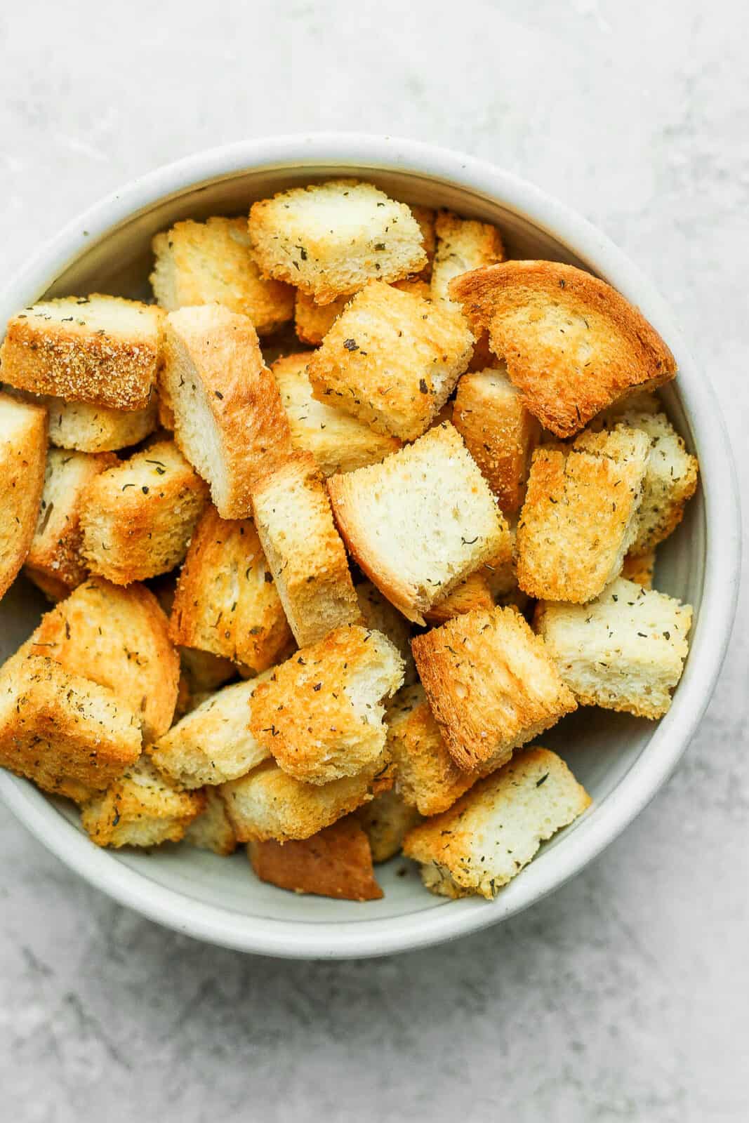 A bowl of homemade croutons that were baked in the oven.