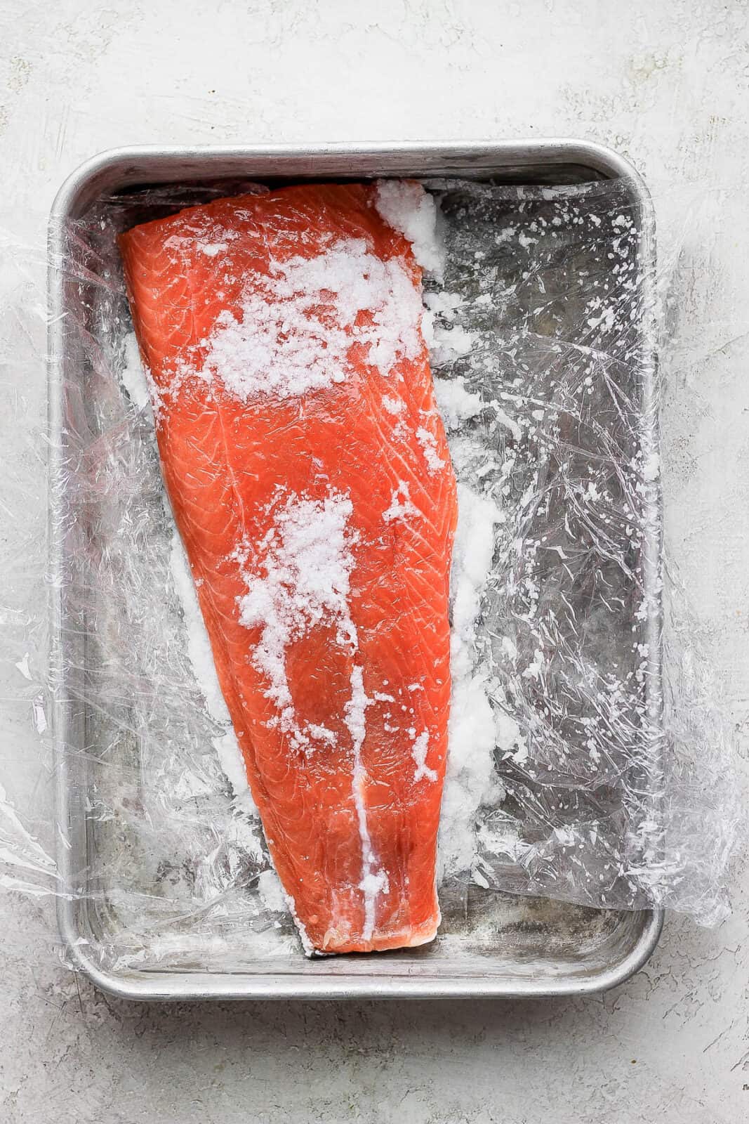 Cured salmon just unwrapped and still covered in a bit of salt. 