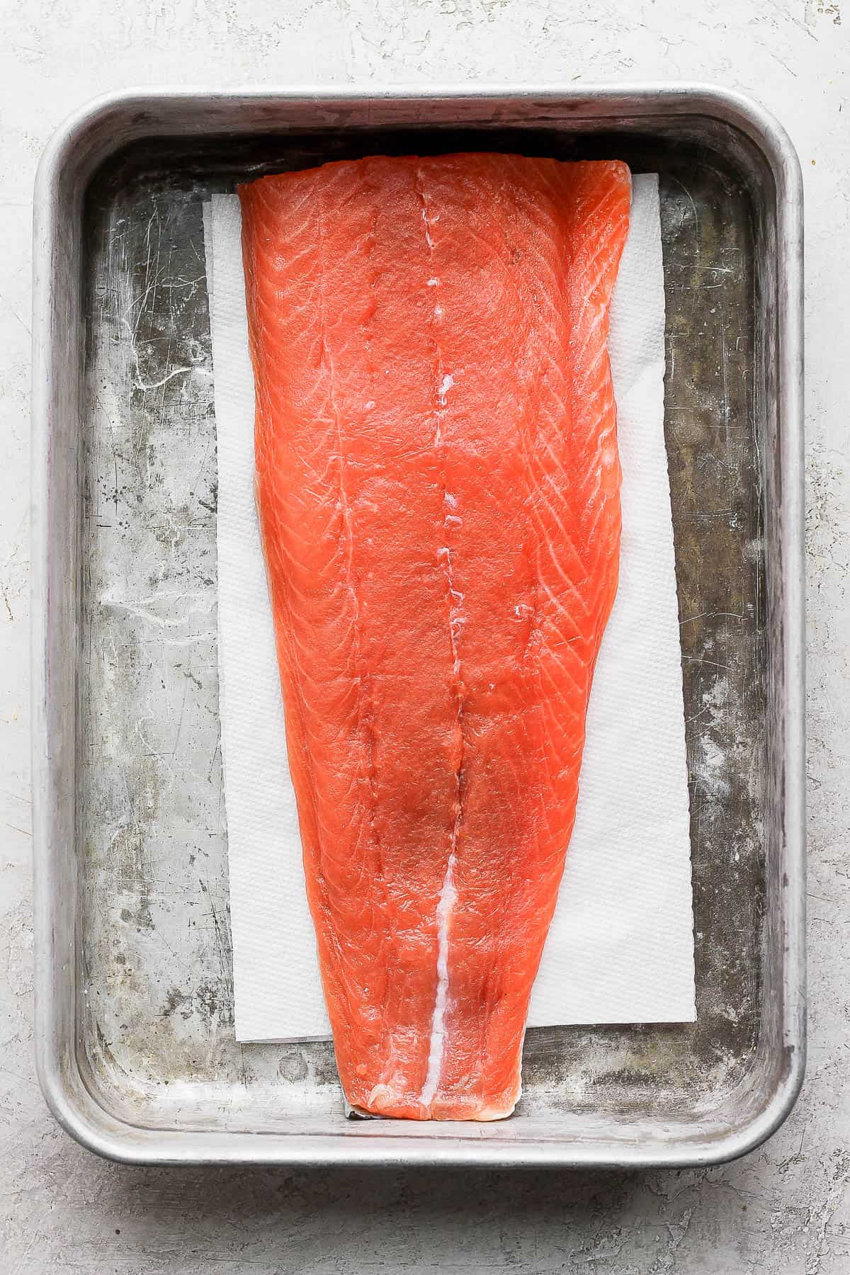 Cured salmon in a baking dish. 