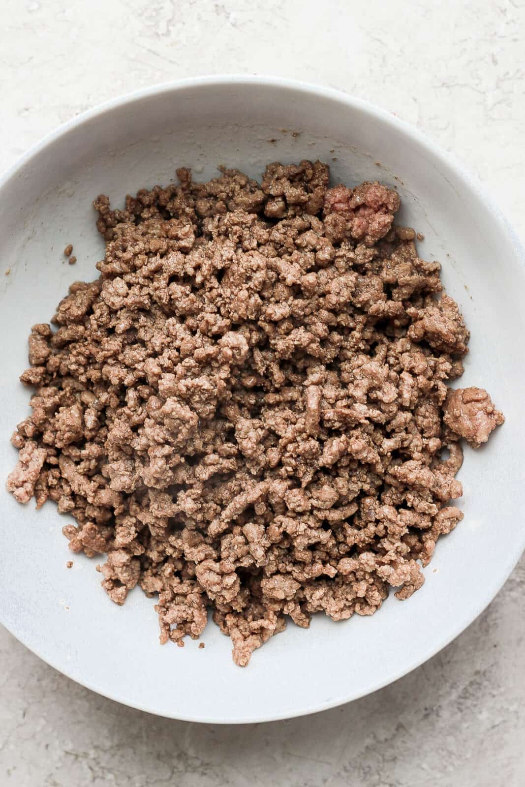 Browned ground beef in a bowl.