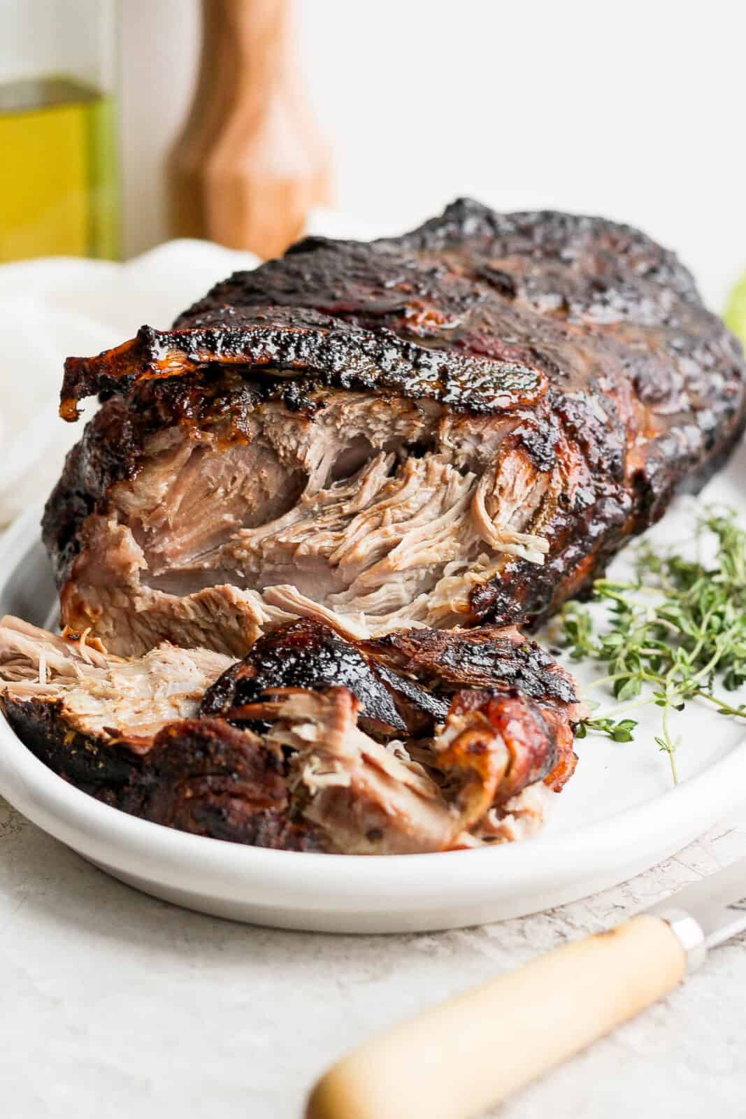 An oven roasted pork shoulder on a platter.
