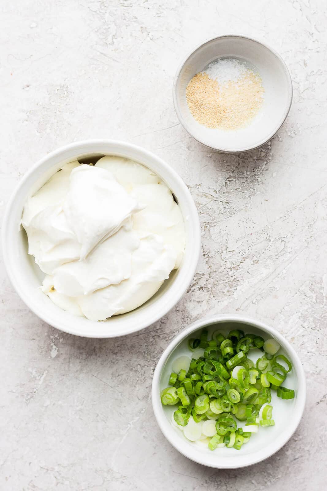 Scallion cream cheese ingredients in separate bowls.